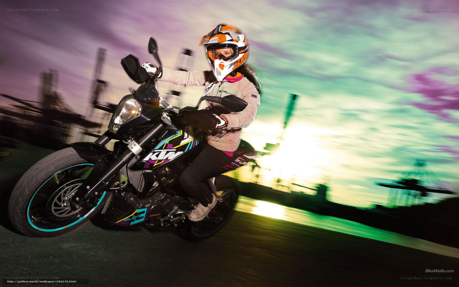 woman riding motorcycle at sunset
