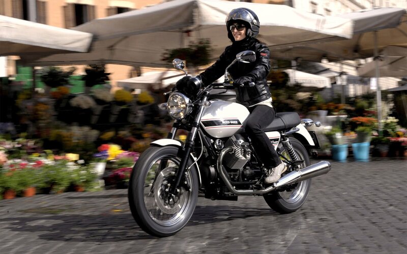 woman riding motorcycle in city