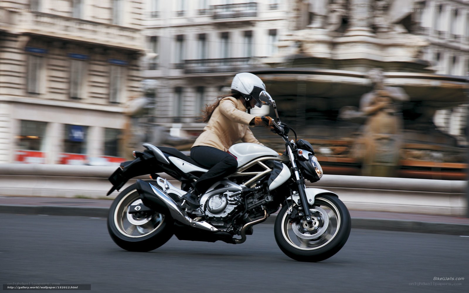 woman riding motorcycle in city