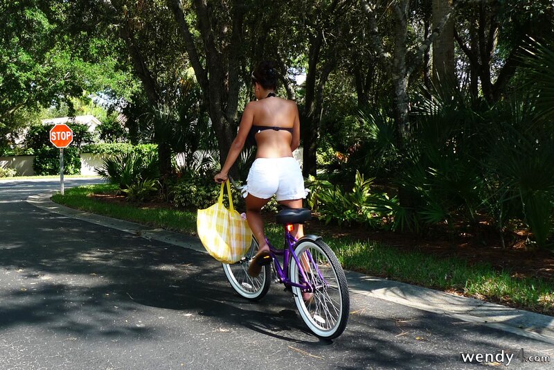 Woman riding purple bike