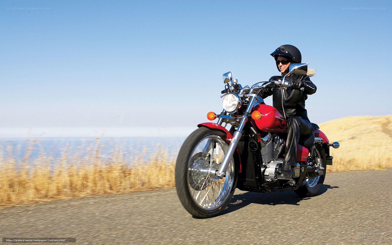 woman riding red motorcycle