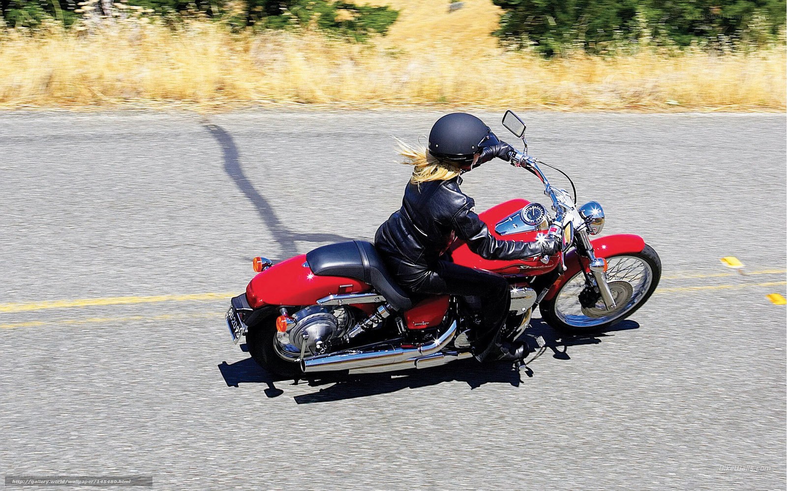 woman riding red motorcycle
