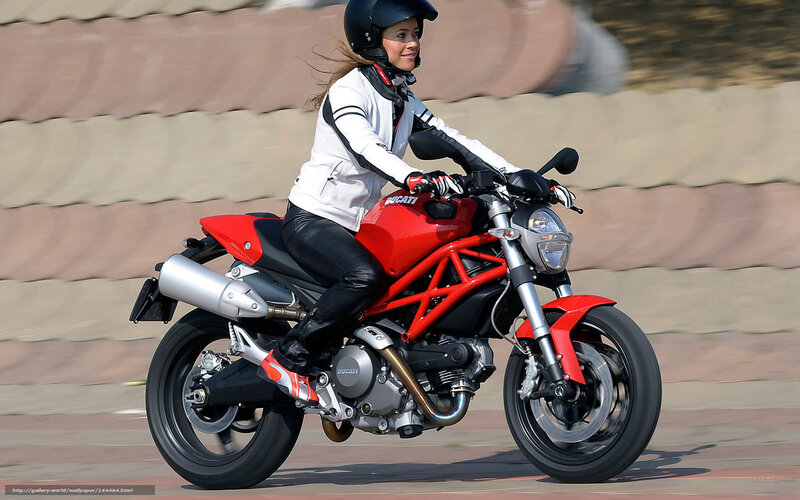 woman riding red motorcycle