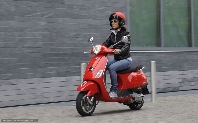 Woman riding red scooter