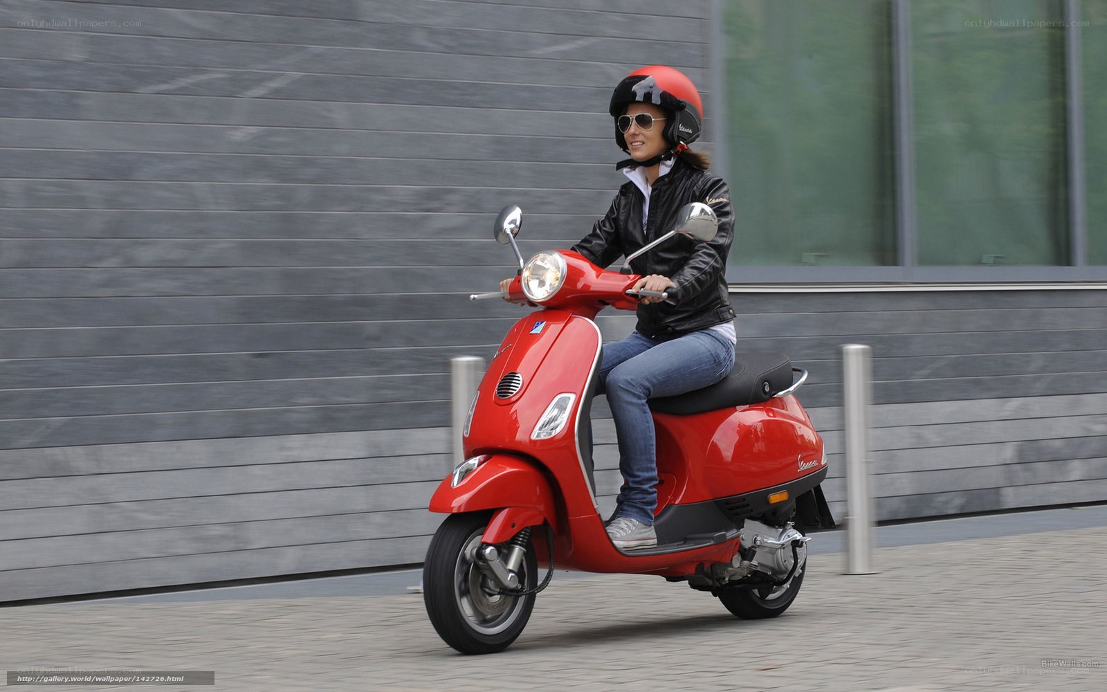 Woman riding red scooter