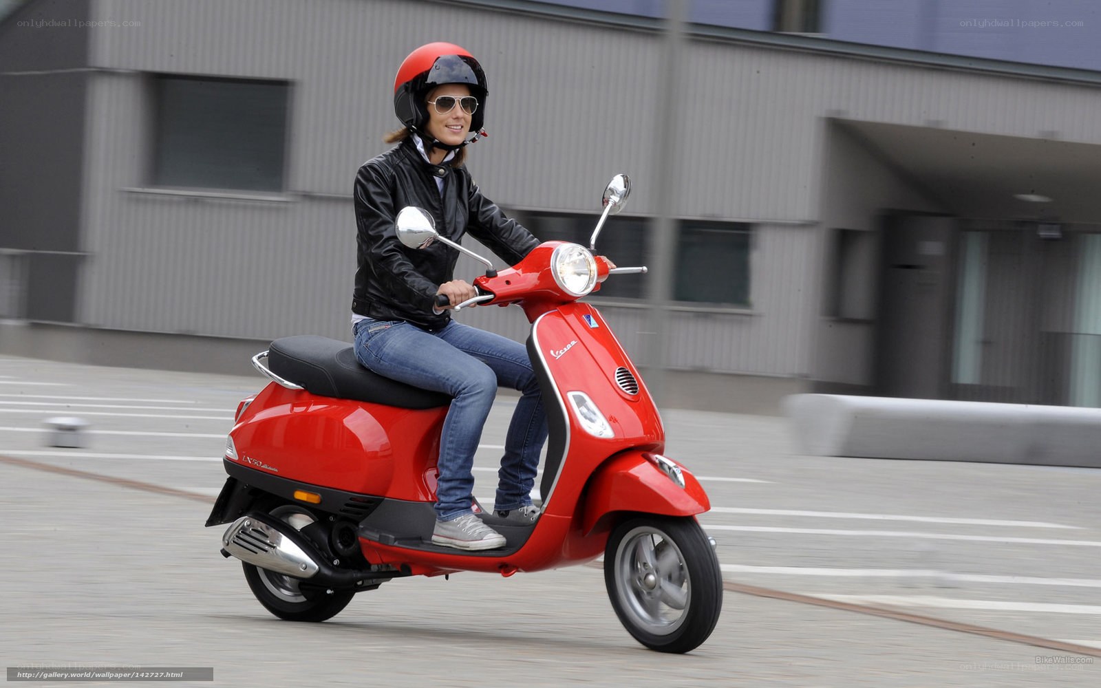 Woman riding red scooter