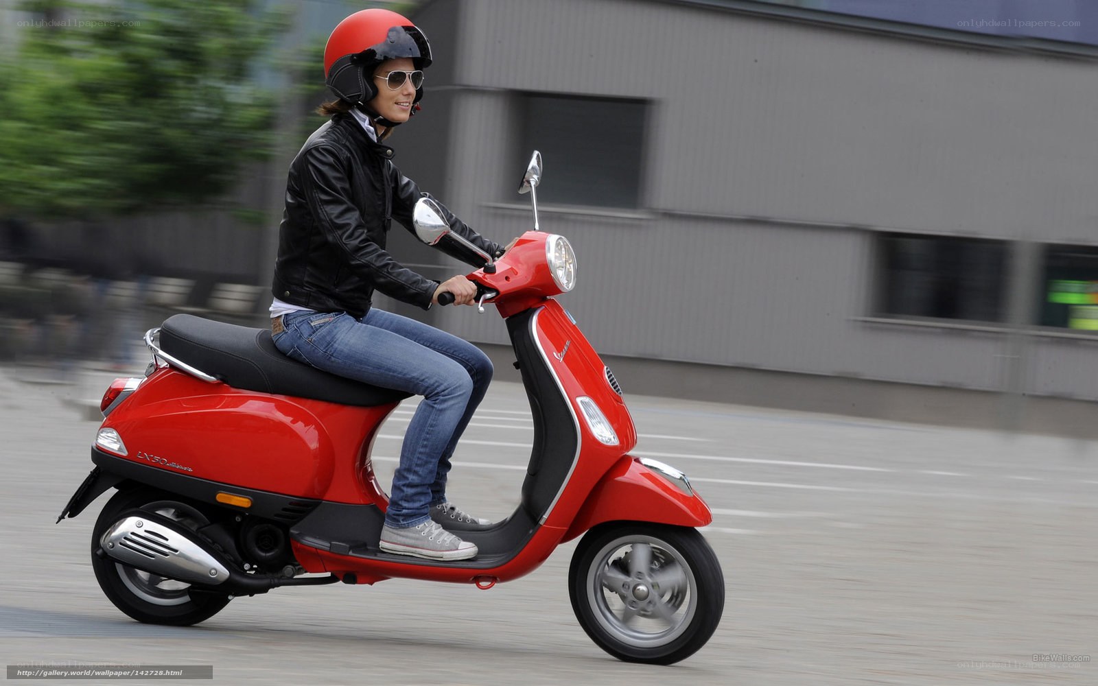 Woman riding red scooter