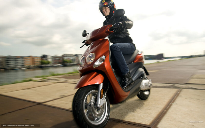 Woman riding red scooter