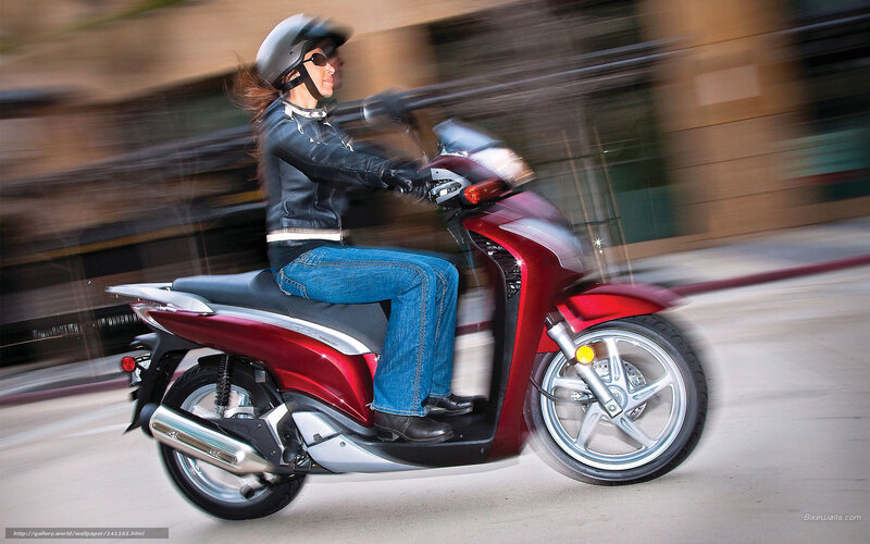 Woman riding red scooter