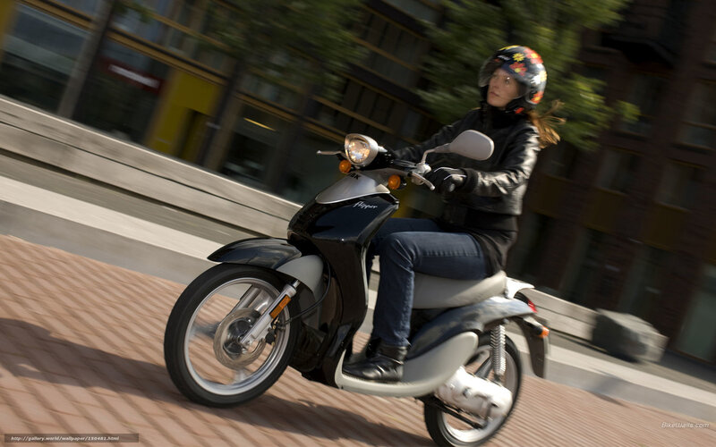 Woman riding scooter in city