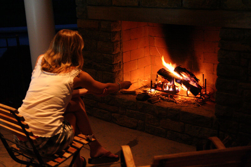 Woman Roasting Marshmallows — Orange