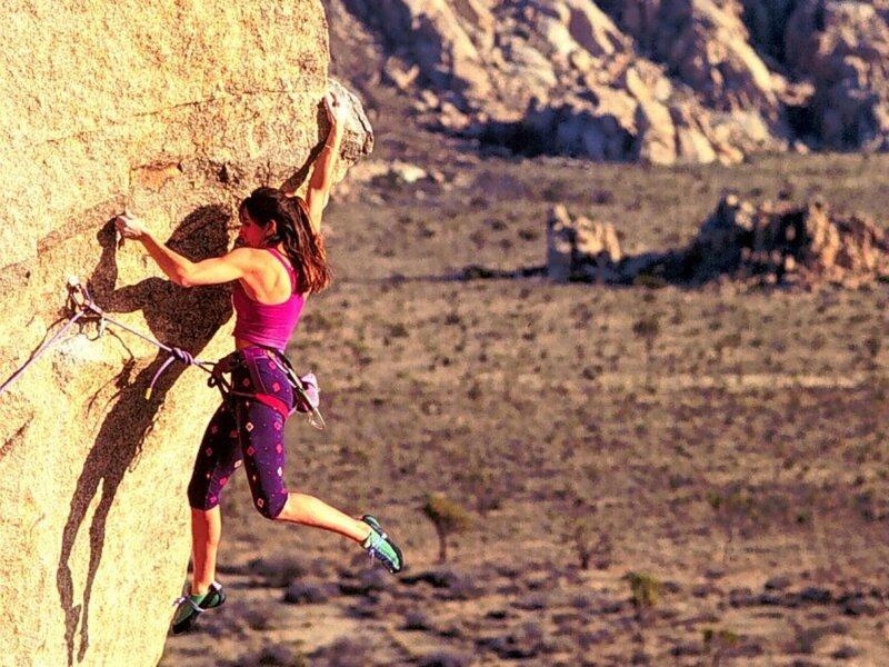 Woman rock climbing in desert