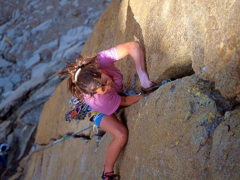 Woman rock climbing on a cliff