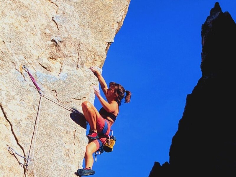 Woman rock climbing on a cliff