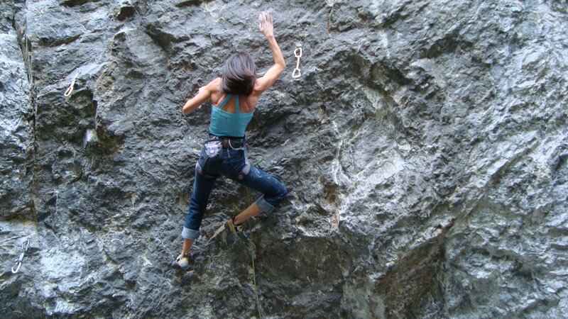 Woman rock climbing on cliff