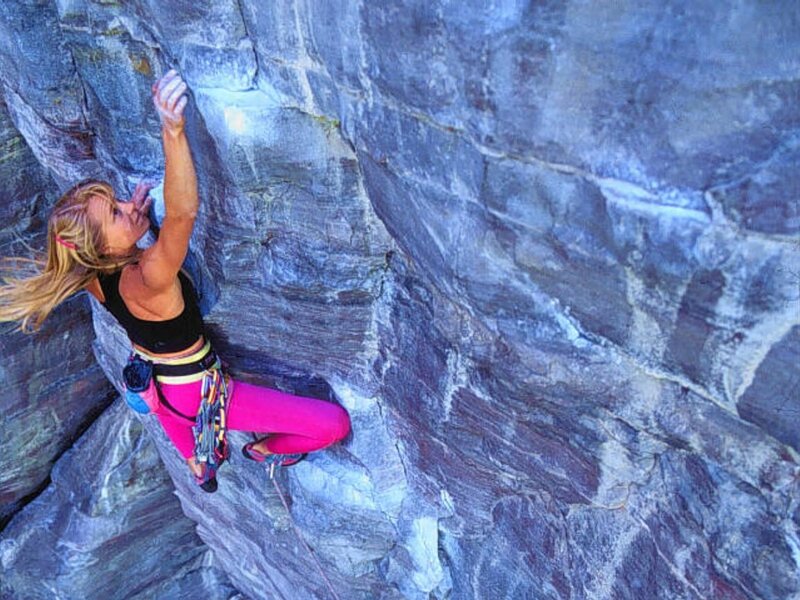 Woman rock climbing on cliff
