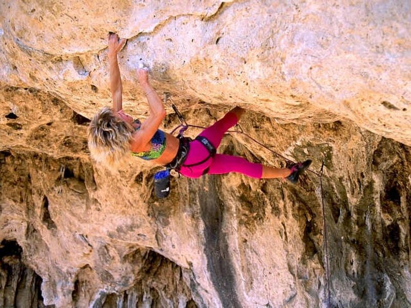 Woman rock climbing on overhang