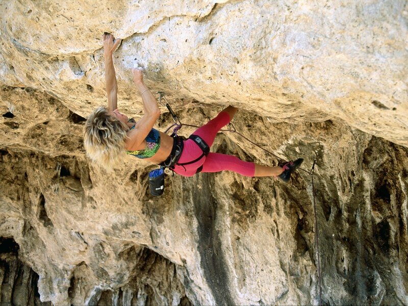 Woman rock climbing on overhang