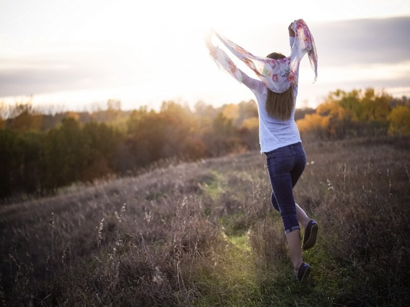 Woman Running in Field — White