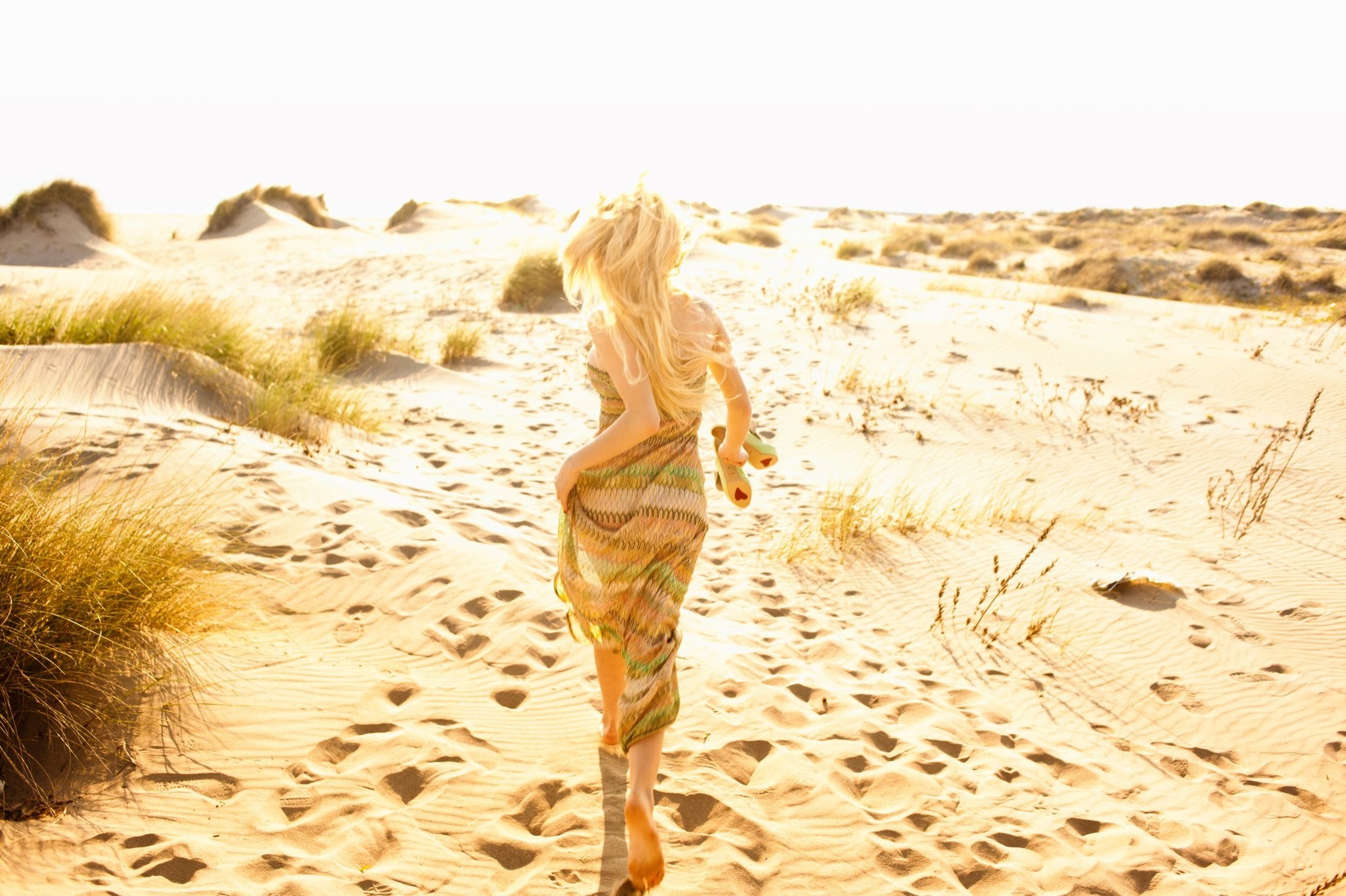 woman running on a sandy dune