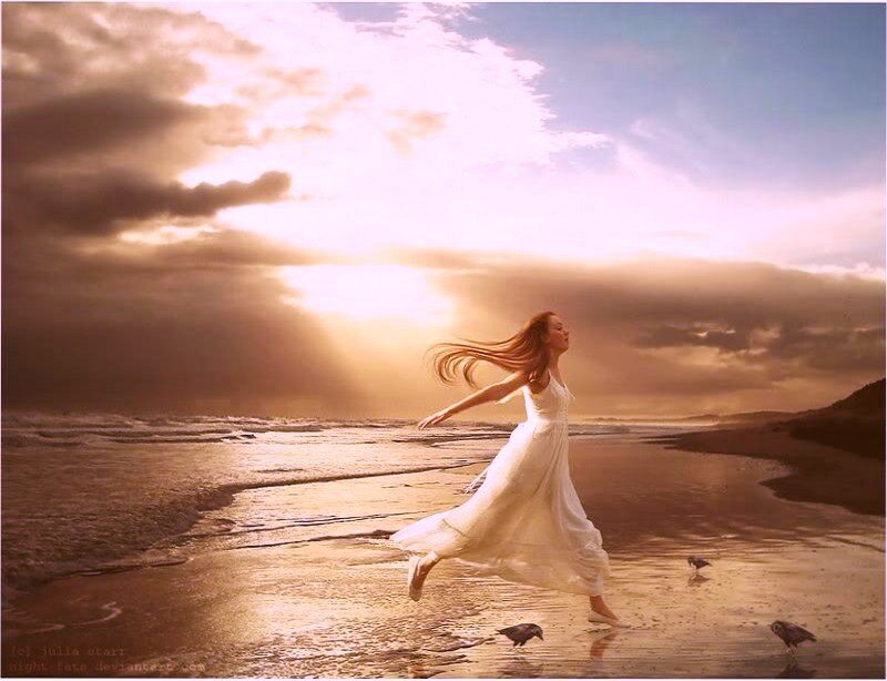Woman running on beach at sunset