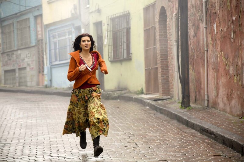 woman running on cobblestone street