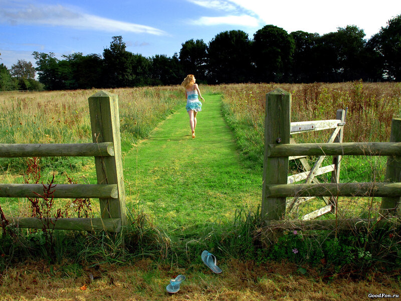 Woman running through a field