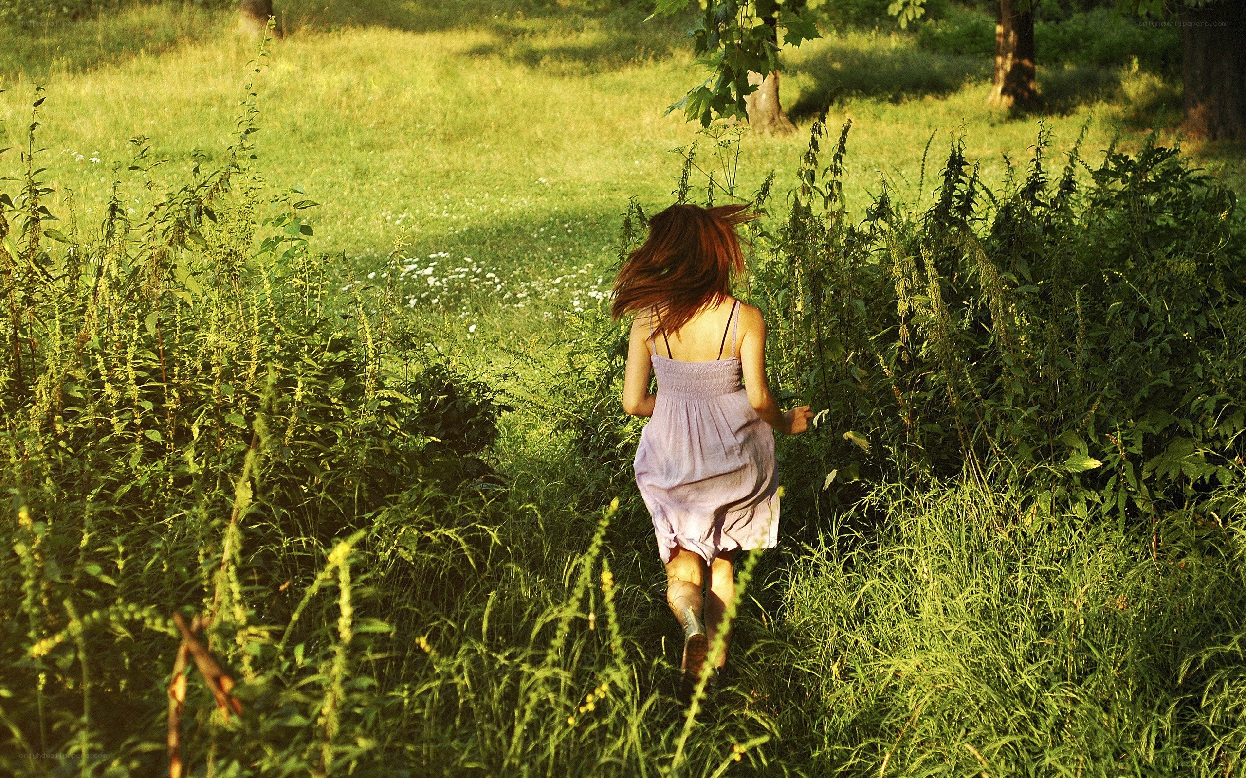 Woman running through a field