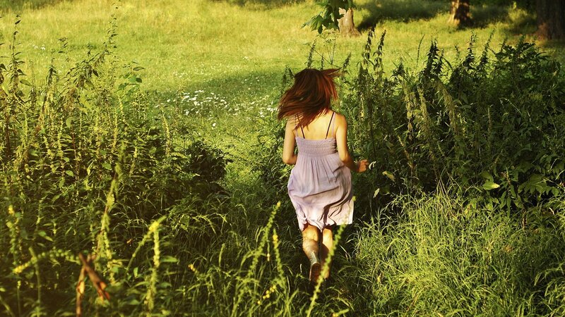 woman running through a field
