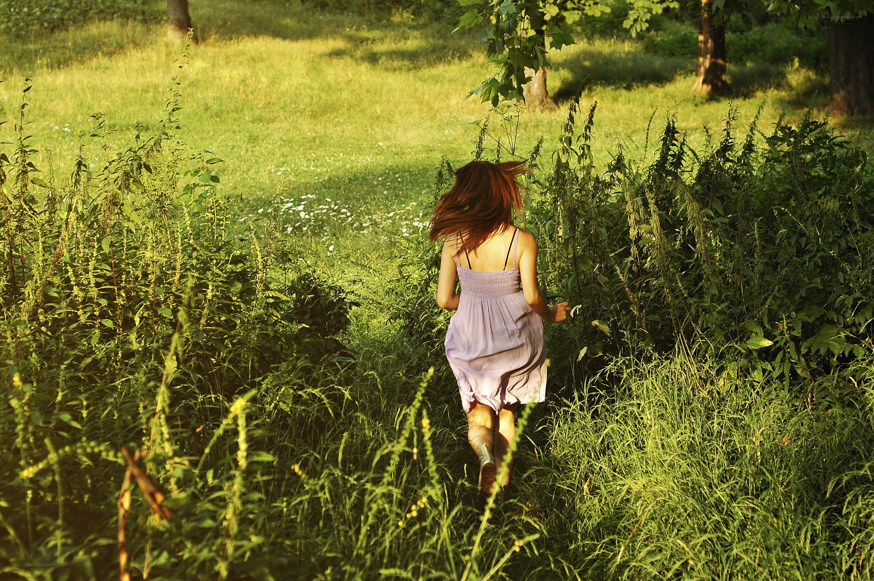 Woman running through a field