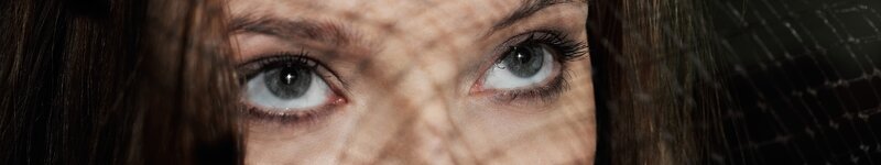 woman's eyes behind netting