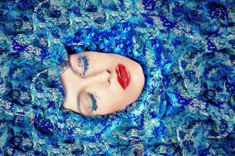 Woman's Face in Blue Fabric