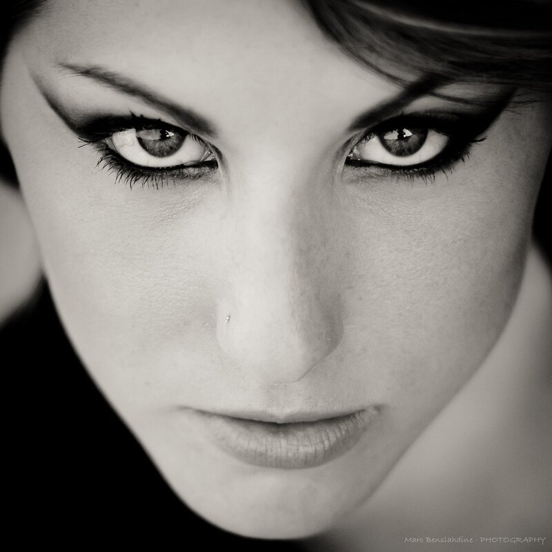 Woman's Face in Close-up — Black, Dramatic, Photograph, Eyes, Nose Piercing