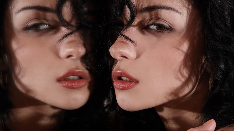 Woman's Face in Mirror