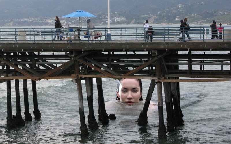 woman's face in water under pier