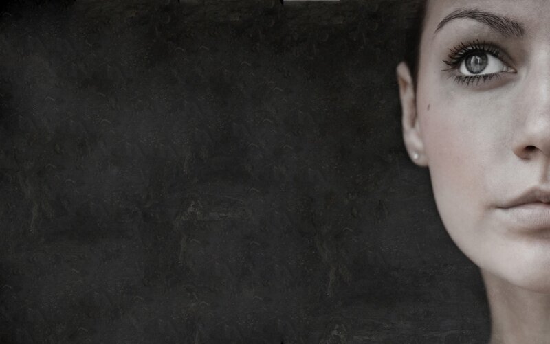 woman's face on dark background