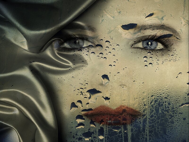 Woman's Face on Wet Glass