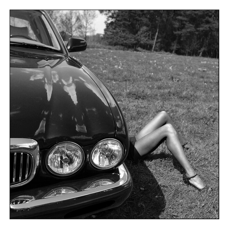 woman's legs by a car