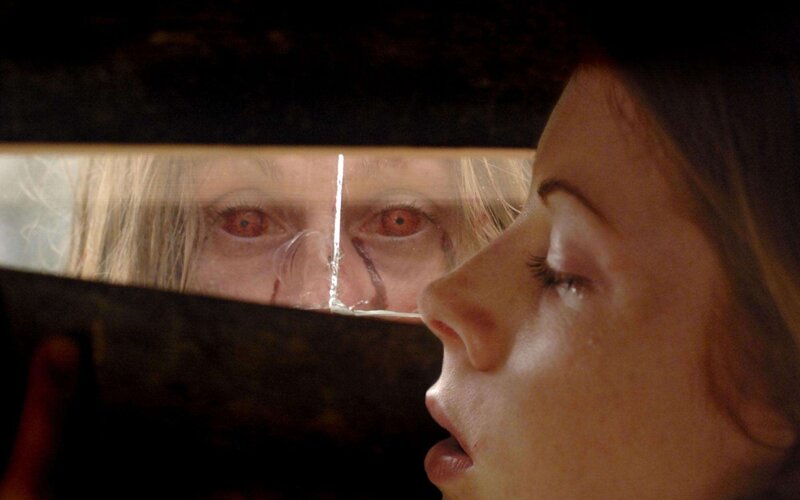 Woman sees reflection in cracked mirror