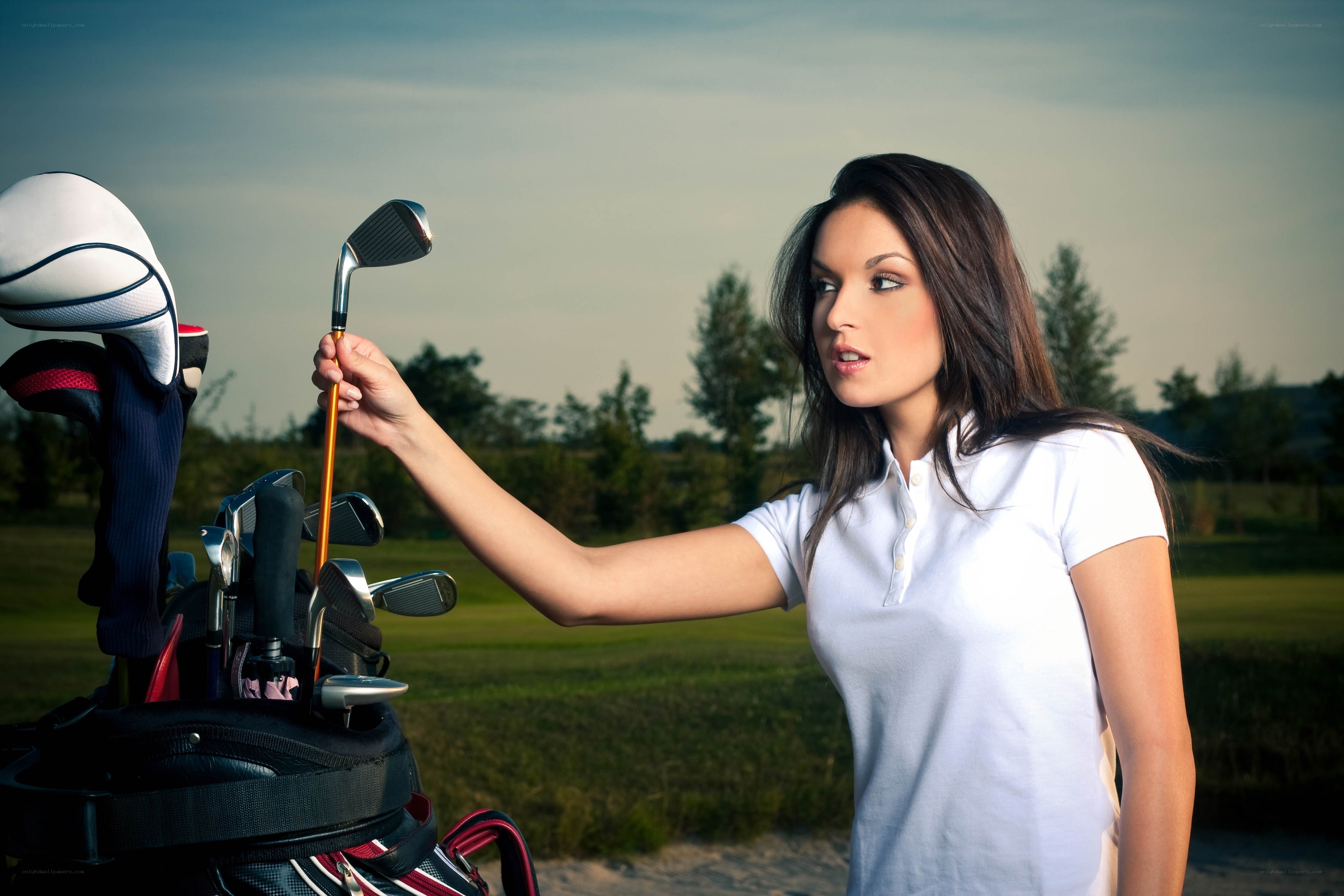 woman selecting golf club