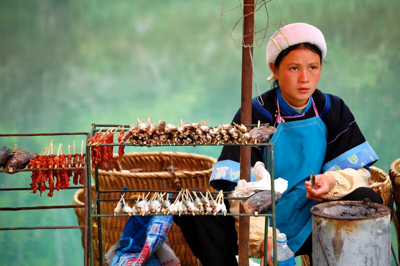 Woman selling grilled food