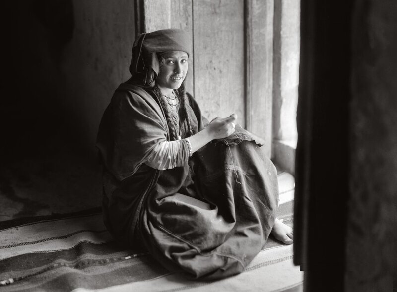 Woman sewing by window