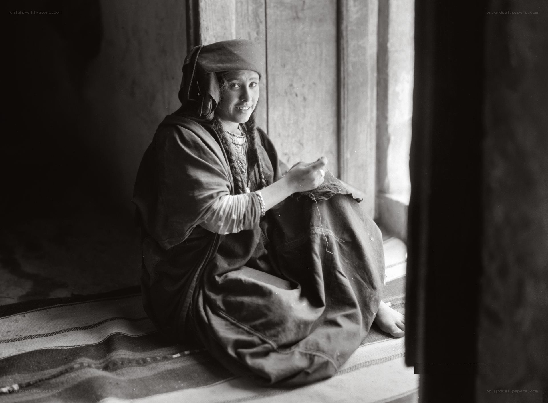 Woman sewing by window