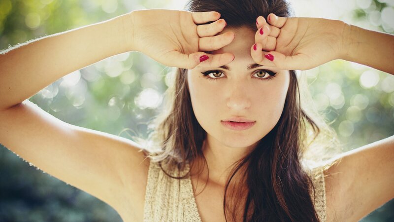 woman shielding eyes from sun