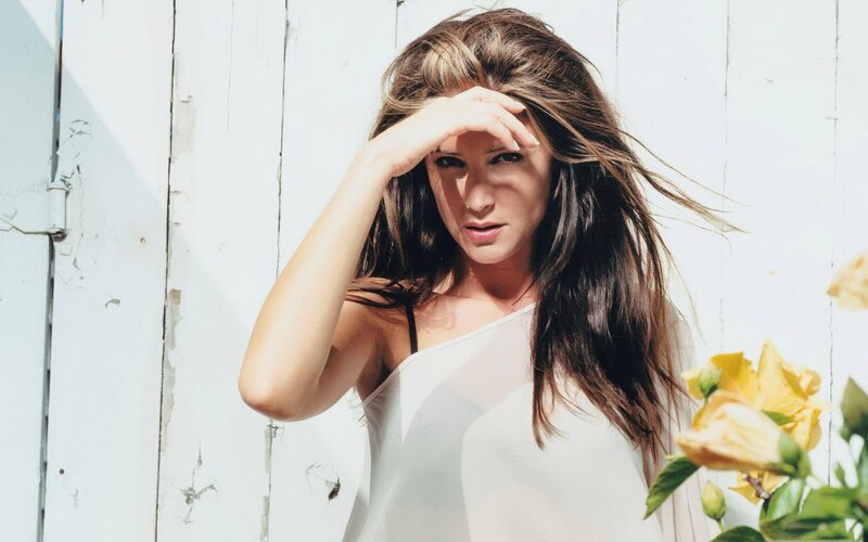 woman shielding eyes from sun