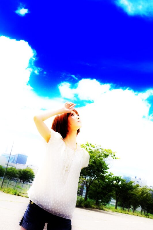 woman shielding eyes from sun