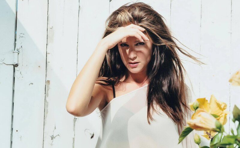 woman shielding eyes from sun
