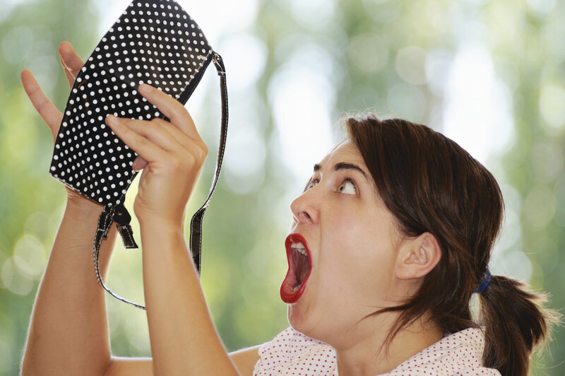 woman shocked by polka dot bag