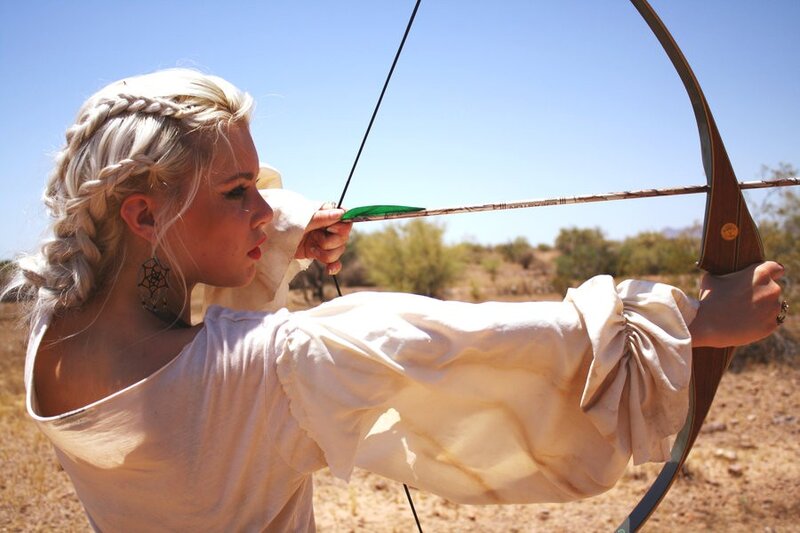 Woman shooting bow and arrow