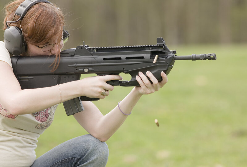 woman shooting rifle at range